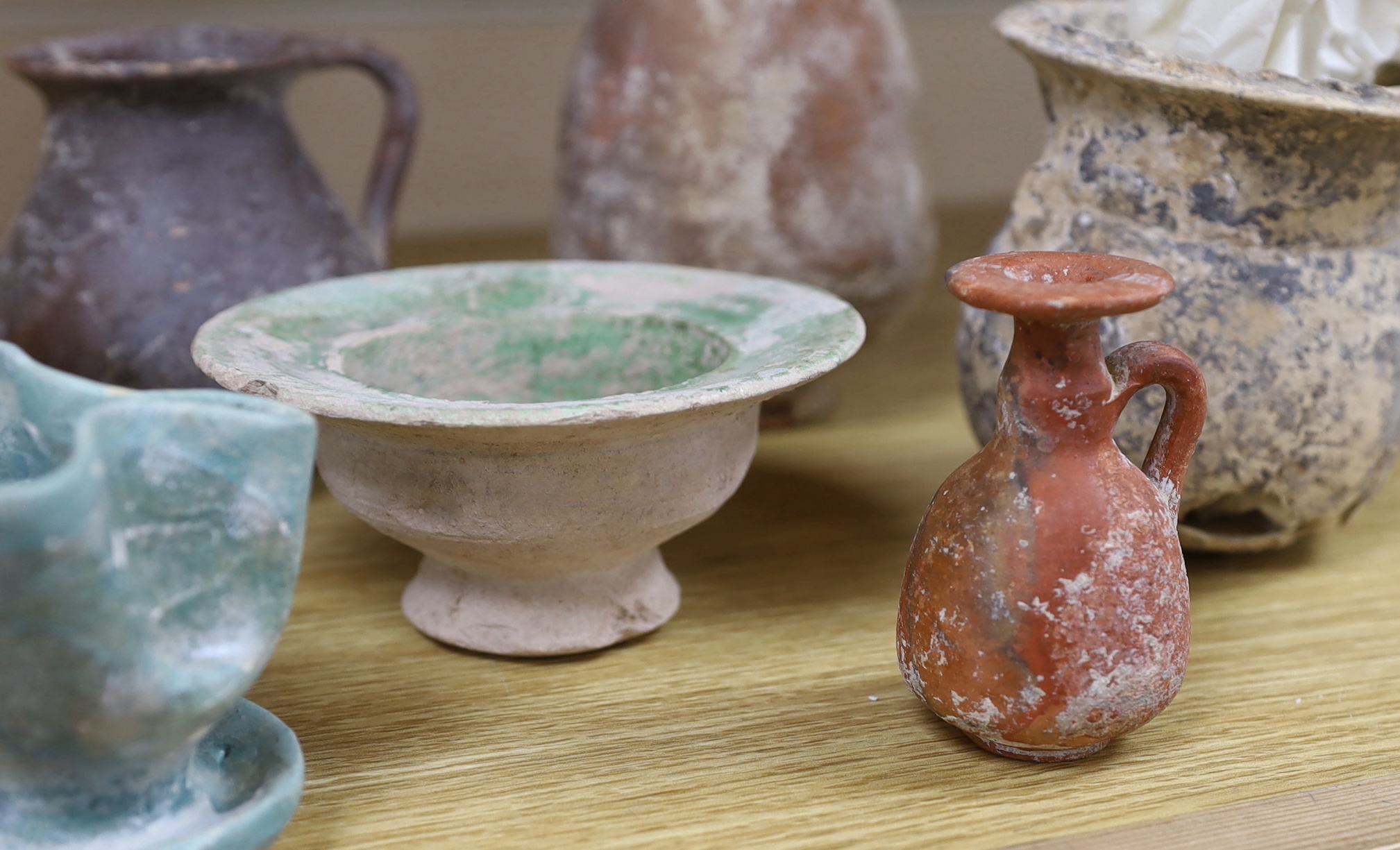 A group of pottery ‘antiquities’, to include Roman, early Christian, Byzantine and Syrian, the largest 17cm high (9), provenance: the owner collected these items in the 1970s, some with original receipts